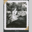 Woman walking with guitar case (ddr-densho-434-213)