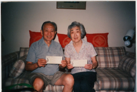 Alice and Frank Endo pose with their reparation checks (ddr-densho-379-446)