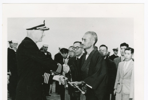 Captain Herbert G. Claudius returns sword to Kenjiro Tobita, former captain in the Imperial Japanese Navy (ddr-densho-1007-123)