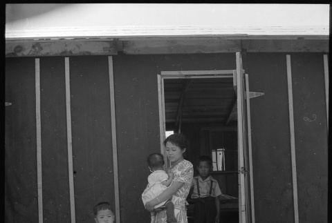 Mother and children outside of barracks (ddr-densho-151-258)