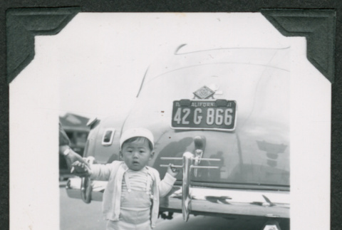 Small child standing next to car (ddr-densho-475-725)