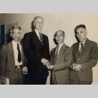 Two men shaking hands, posing with two others (ddr-njpa-2-966)