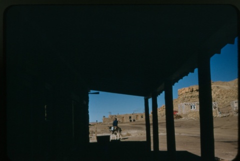 A man riding a donkey in the desert (ddr-densho-338-500)