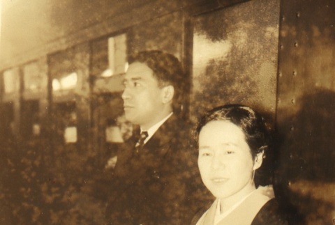 Woman standing with man by train (ddr-njpa-4-122)