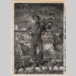 Man leaning on wire fence (ddr-densho-466-249)