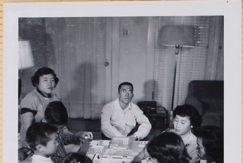 Group playing Monopoly (ddr-densho-522-549)