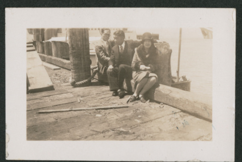 two men and one woman sitting on a deck (ddr-densho-378-774)