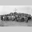 Group gathered in front of an outdoor cross in camp (ddr-fom-1-100)