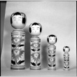 Four wooden figures on display (ddr-densho-426-2211)