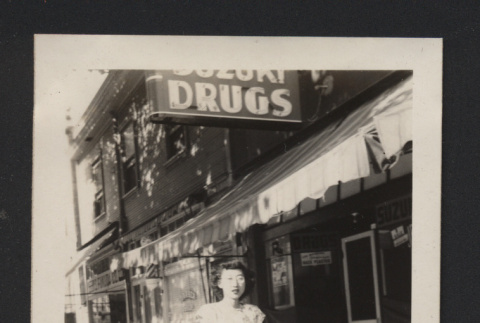 Photograph of Suzuki family member in front of Suzuki Drugs (ddr-csujad-55-2647)