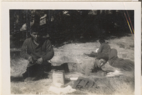 Four men laying on grass (ddr-densho-466-254)