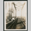 A young woman on a train bridge (ddr-densho-378-382)