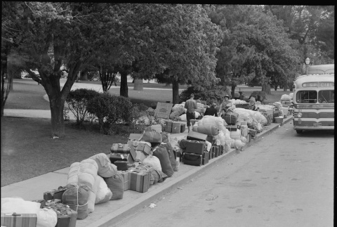 Baggage of Japanese Americans lining the street (ddr-densho-151-164)