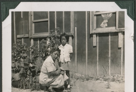 Woman and girl by camp garden plot (ddr-densho-321-78)