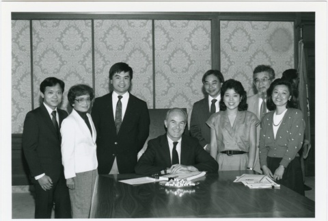 Governor Booth Gardner signing redress a document (ddr-densho-10-18)