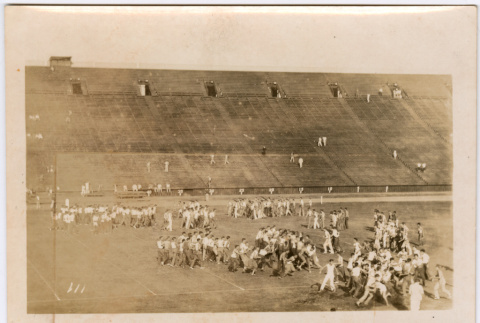 Large group wrestling on field in stadium (ddr-densho-329-1370)