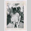 Photo of a child holding a stick (ddr-densho-483-736)