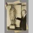 Man pointing at a statue (ddr-njpa-13-1533)