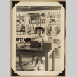 Rose Nomura at a warehouse (ddr-densho-542-530)