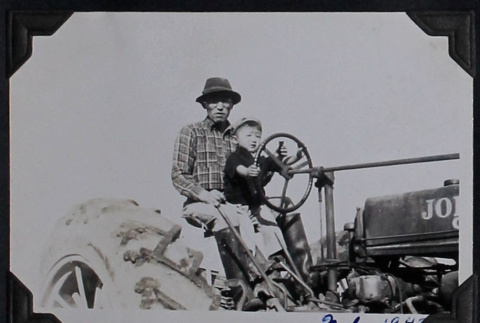 Man and boy on tractor (ddr-densho-359-1509)