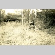Soldier laying in a field (ddr-densho-22-226)