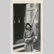 Woman standing in front of a barracks entrance (ddr-manz-7-44)
