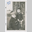 Two children in coats outside brick building (ddr-densho-483-640)