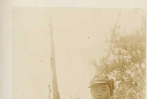 A young soldier seated with a rifle (ddr-njpa-6-20)