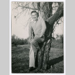 Man leaning on tree (ddr-densho-475-245)