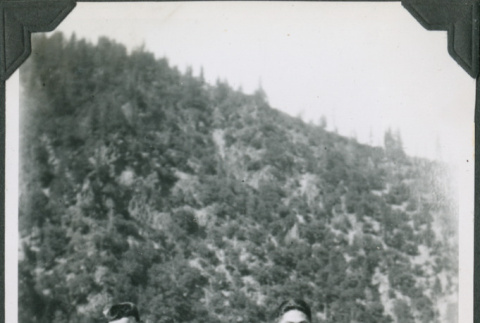 Three men standing with buildings and hill in background.  Joe Iwataki on right (ddr-ajah-2-336)