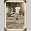 Frank Eya outside a barrack (ddr-densho-542-549)