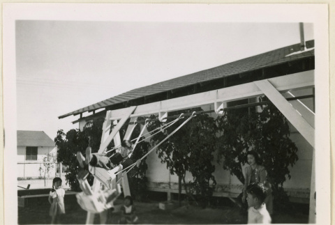 Children playing on a swing (ddr-densho-37-1062)