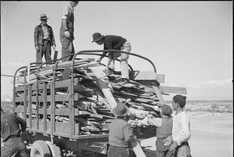 Japanese American workers loading scrap lumber (ddr-densho-37-555)