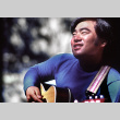 Ted Hasegawa playing guitar at morning watch (ddr-densho-336-1240)
