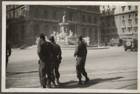 Men in uniform with statue in background (ddr-densho-466-134)