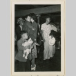 Boy holds a doll while waiting for the bus (ddr-densho-37-894)