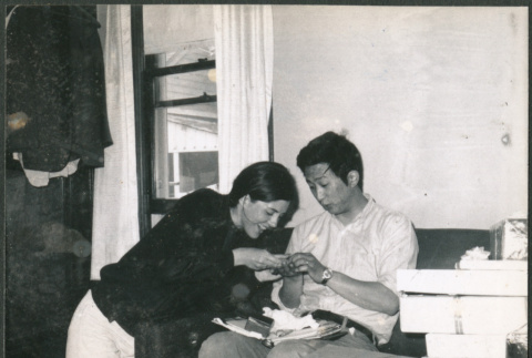 Couple looking at gifts (ddr-densho-523-530)