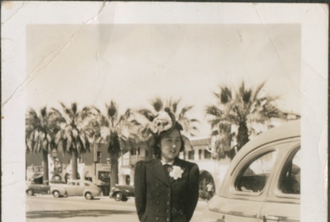 A woman standing next to a car (ddr-densho-316-33)