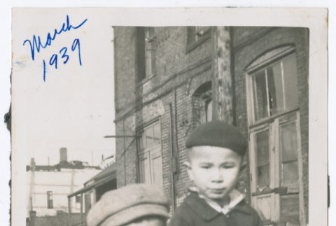 Two children in coats outside brick building (ddr-densho-483-640)