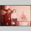 Couple next to TV in electronics store (ddr-densho-523-450)