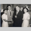 John H. Wilson posing with another man and two nurses (ddr-njpa-2-903)
