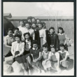 Photograph of a group of people posing in front of the Manzanar hospital (ddr-csujad-47-208)
