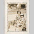Pauline Sakahara and Arlene Sakahara sitting with a dog (ddr-densho-316-68)