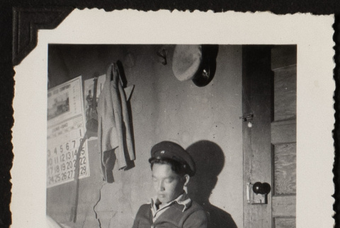 Roy reading a newspaper (ddr-densho-542-365)
