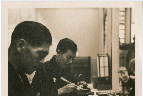 Two men demonstrating carving at Japanese Pavilion (ddr-densho-426-2097)