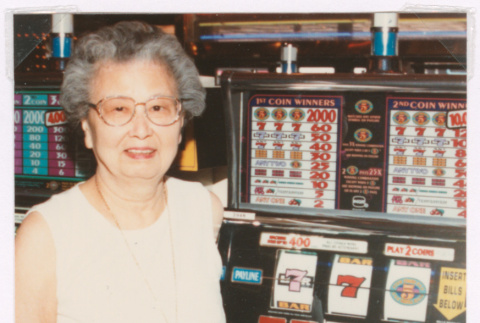 Mitzi Isoshima with a fanny pack winning at the slots (ddr-densho-477-762)