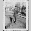 Man in uniform standing by houses (ddr-densho-434-450)