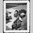 Man laying on cot with gear outside (ddr-densho-434-420)