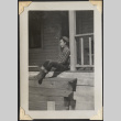 Man sitting on porch, likely Minoru Muromoto (ddr-densho-466-910)