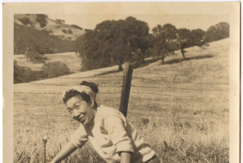 Woman standing by water tap in field (ddr-densho-426-214)